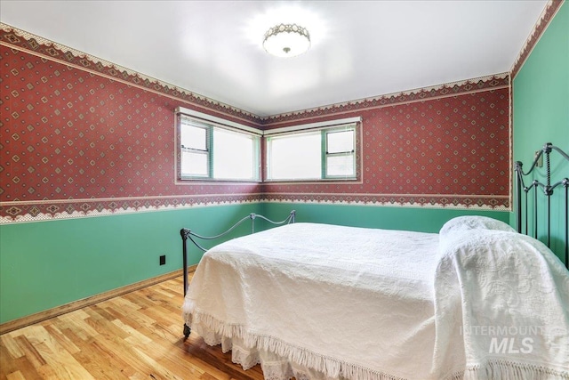 2011 Schodde, Burley, ID 83318 - bedroom with wallpapered walls, wood finished floors, and baseboards