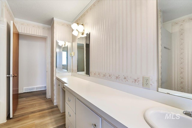 2011 Schodde, Burley, ID 83318 - full bath with crown molding, wood finished floors, wallpapered walls, and vanity