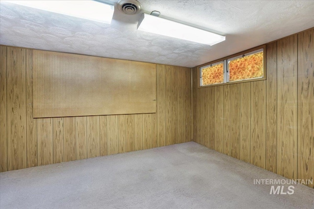 2011 Schodde, Burley, ID 83318 - basement with wooden walls, carpet floors, and a textured ceiling
