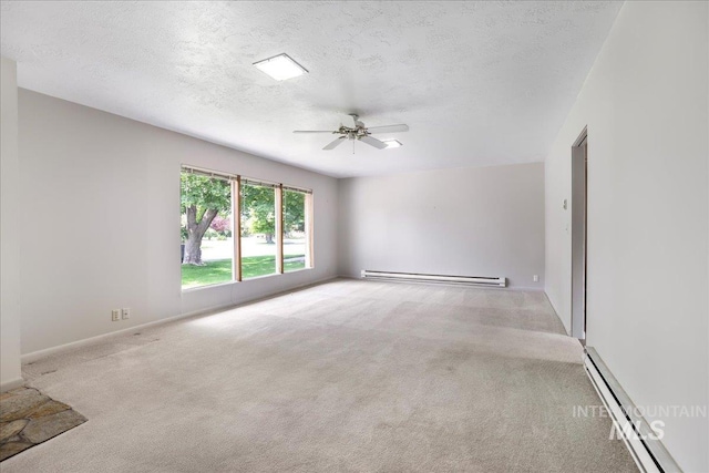 2011 Schodde, Burley, ID 83318 - empty room featuring a baseboard heating unit, carpet flooring, baseboard heating, ceiling fan, and a textured ceiling