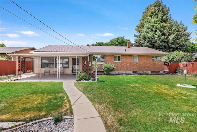 2011 Schodde, Burley, ID 83318 - rear view of property with a patio area, a chimney, brick siding, and metal roof