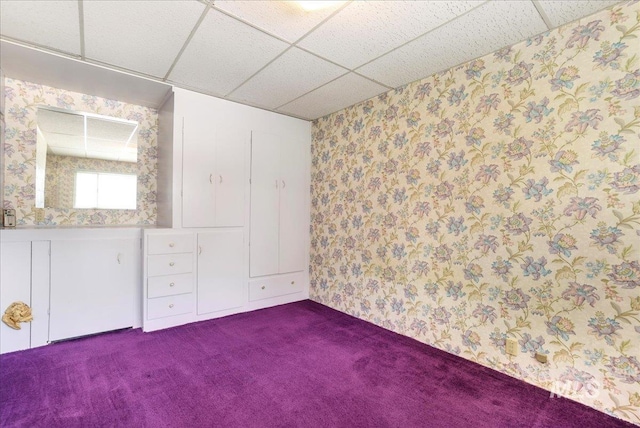 2011 Schodde, Burley, ID 83318 - unfurnished bedroom featuring a paneled ceiling, dark carpet, and wallpapered walls