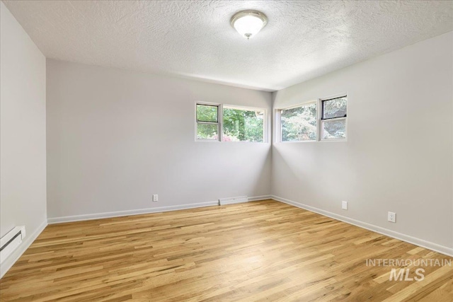 2011 Schodde, Burley, ID 83318 - spare room with light wood finished floors, a textured ceiling, and baseboards