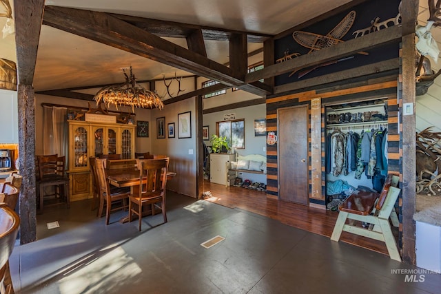 dining room with vaulted ceiling with beams