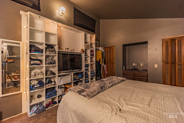 carpeted bedroom featuring lofted ceiling