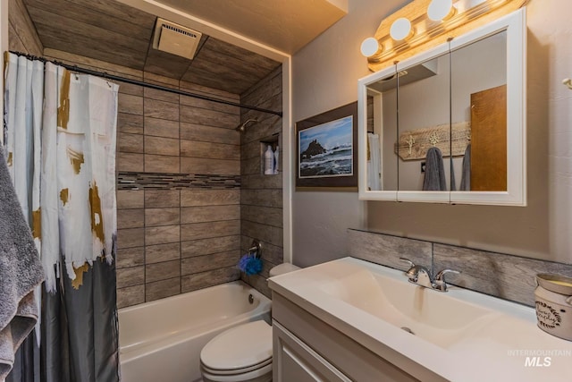 full bathroom with vanity, shower / tub combo, and toilet