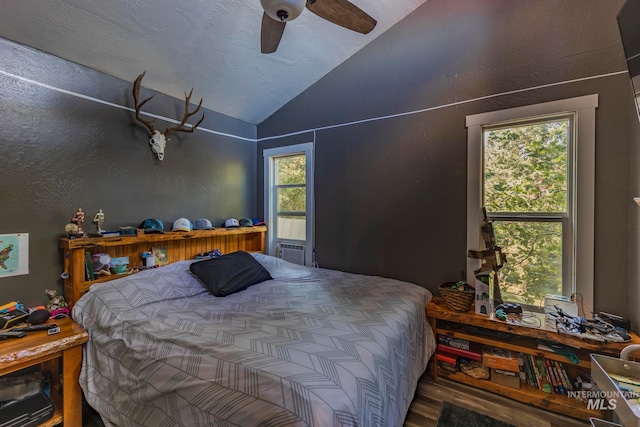 bedroom featuring wood-type flooring, vaulted ceiling, and ceiling fan