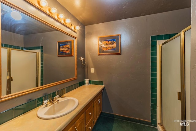 bathroom with walk in shower and vanity