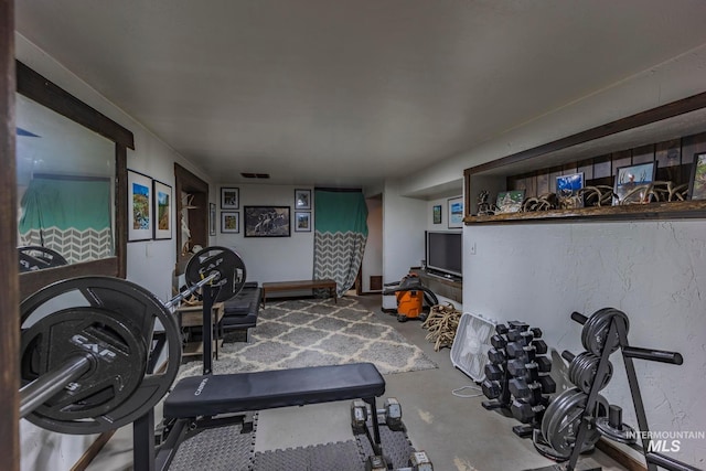 workout room featuring concrete floors