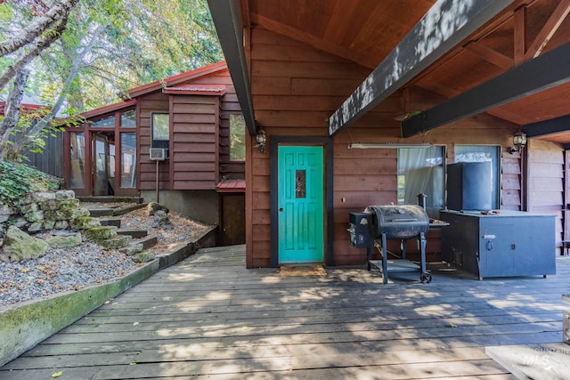 entrance to property featuring a wooden deck