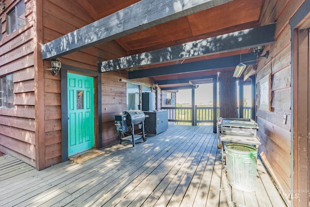 wooden deck featuring a grill