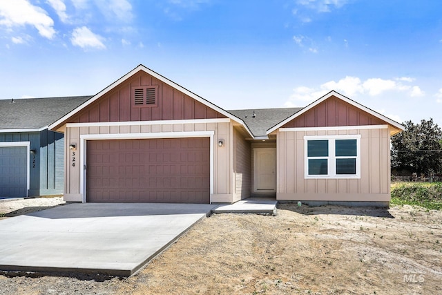 324 Packer Ln, Homedale, ID 83628 - view of front of property with a garage, a shingled roof, concrete driveway, and board and batten siding