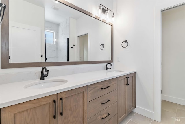 bathroom with walk in shower, vanity, and tile patterned flooring