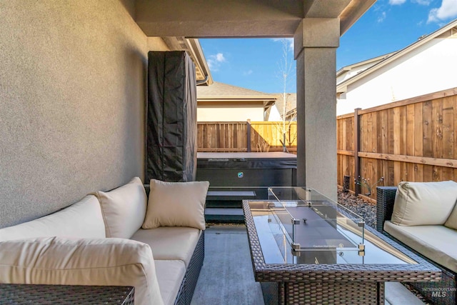 view of patio / terrace with a hot tub