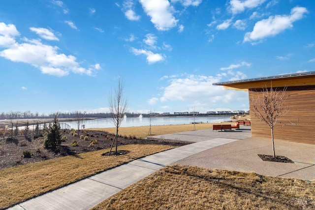 view of yard with a patio and a water view