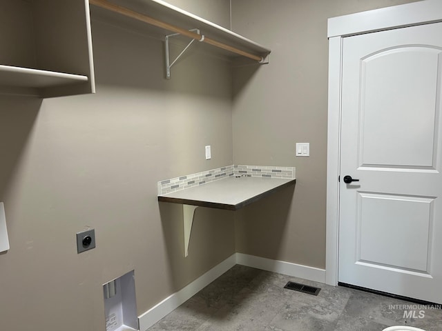 washroom with hookup for an electric dryer