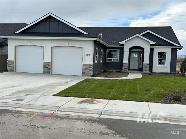 craftsman-style house with a front yard and a garage