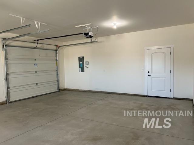 garage featuring electric panel and a garage door opener