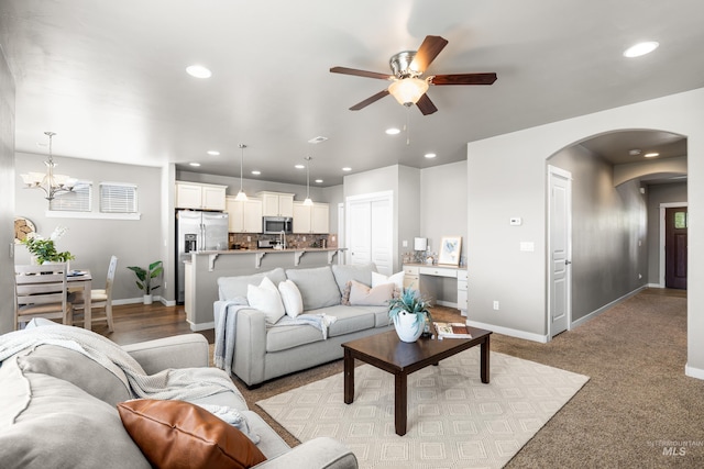11661 W Baserri, Boise, ID 83709 - living room with arched walkways, a ceiling fan, baseboards, a chandelier, and recessed lighting