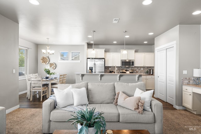 11661 W Baserri, Boise, ID 83709 - living area with a chandelier, recessed lighting, baseboards, and dark wood-style floors