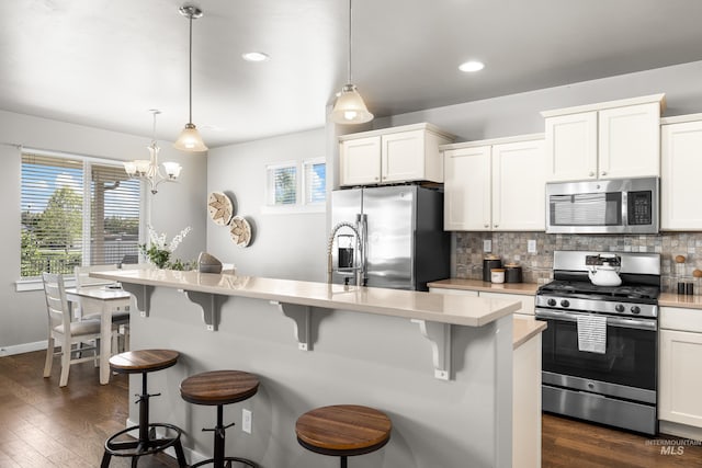 11661 W Baserri, Boise, ID 83709 - kitchen with stainless steel appliances, light countertops, plenty of natural light, decorative backsplash, and recessed lighting