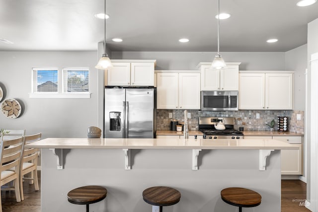 11661 W Baserri, Boise, ID 83709 - kitchen featuring stainless steel appliances, dark wood-style flooring, decorative backsplash, and recessed lighting
