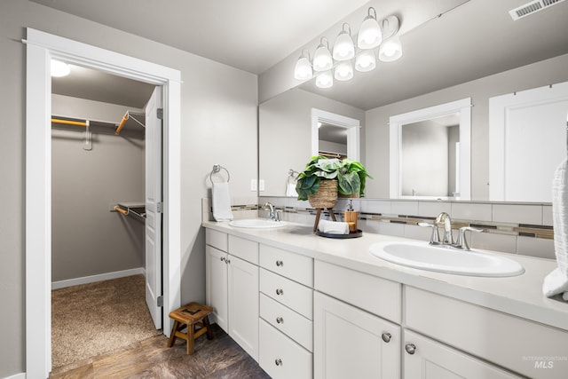 11661 W Baserri, Boise, ID 83709 - bathroom with double vanity, a walk in closet, and baseboards