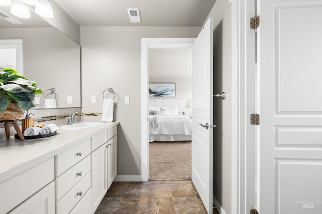 11661 W Baserri, Boise, ID 83709 - ensuite bathroom featuring vanity, baseboards, stone finish floors, and backsplash