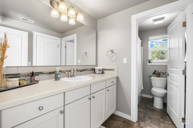 11661 W Baserri, Boise, ID 83709 - full bathroom with vanity, baseboards, toilet, stone finish flooring, and a shower with curtain