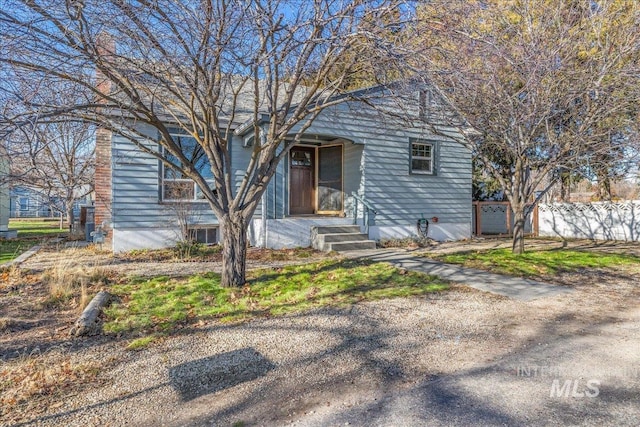 view of front of home featuring fence