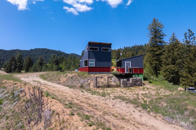 7 Ridgetop Pl, Boise, ID 83716 - rear view of property featuring a view of trees, board and batten siding, and a wooden deck