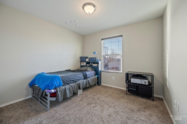 bedroom with a textured ceiling and carpet