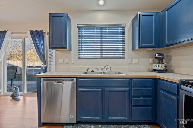 kitchen featuring blue cabinets, sink, and appliances with stainless steel finishes