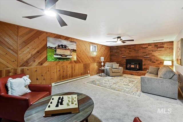 carpeted living room with baseboard heating and wood walls