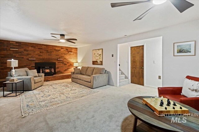 living room with light colored carpet and a wood stove