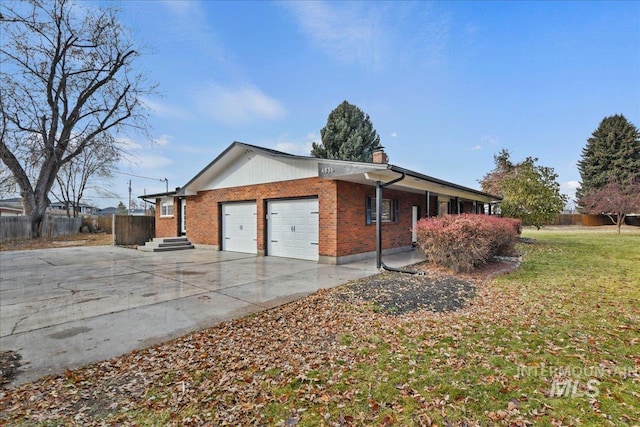 view of side of home featuring a yard and a garage