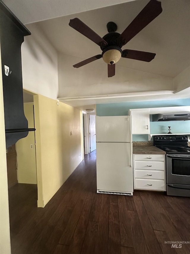kitchen with white cabinets, lofted ceiling, dark countertops, freestanding refrigerator, and electric range oven