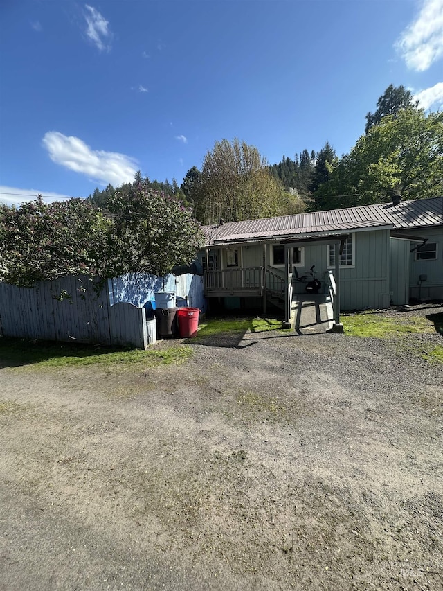 rear view of property featuring metal roof