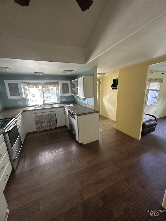 kitchen featuring dark countertops, open shelves, stainless steel appliances, white cabinetry, and dark wood-style flooring