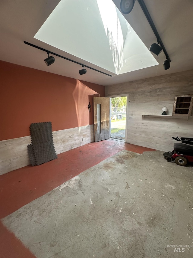 unfurnished living room with concrete flooring and a garage
