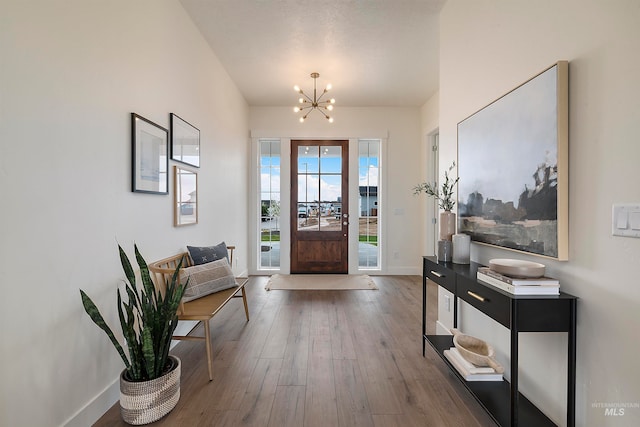 foyer featuring a notable chandelier and dark hardwood / wood-style floors