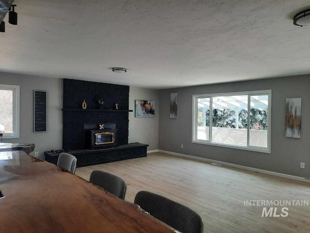 39992 Waha Glen Rd, Lewiston, ID 83501 - living area featuring a brick fireplace, baseboards, plenty of natural light, and light wood-style floors