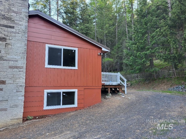 39992 Waha Glen Rd, Lewiston, ID 83501 - view of property exterior featuring a deck, a wooded view, and fence