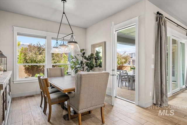 2357 N Synergy Pl, Eagle, ID 83616 - dining room with light wood-style flooring, baseboards, and plenty of natural light