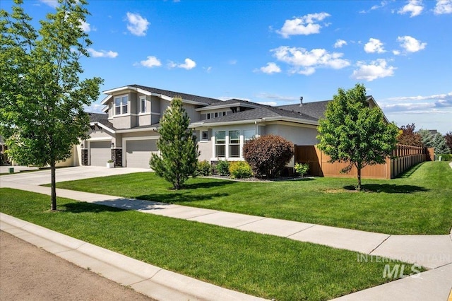 2357 N Synergy Pl, Eagle, ID 83616 - view of front of home featuring an attached garage, stucco siding, and driveway
