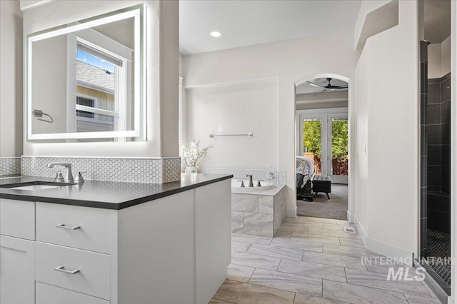 2357 N Synergy Pl, Eagle, ID 83616 - full bathroom with french doors, ceiling fan, vanity, a bath, and a tile shower