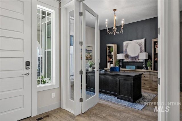 2357 N Synergy Pl, Eagle, ID 83616 - foyer entrance featuring light wood finished floors, a chandelier, and baseboards