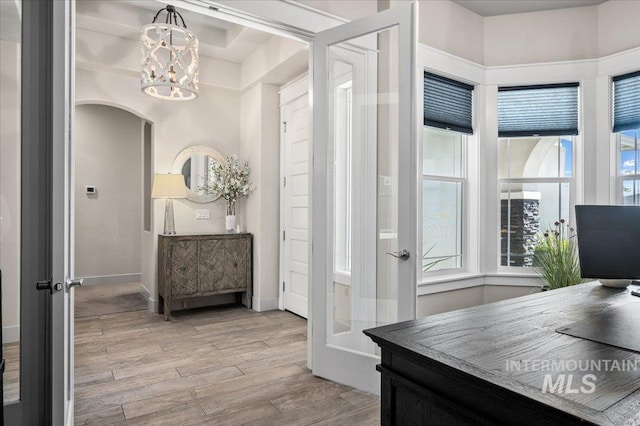 2357 N Synergy Pl, Eagle, ID 83616 - home office with light wood-type flooring, a chandelier, and arched walkways