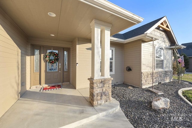 view of exterior entry with a porch