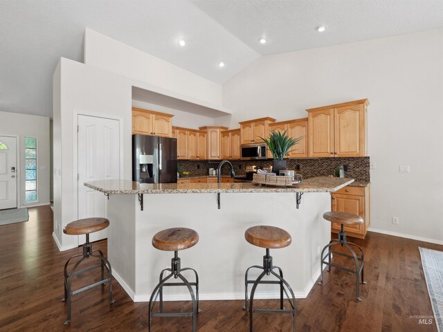 1415 E Lake Crk, Meridian, ID 83642 - kitchen featuring appliances with stainless steel finishes, a large island, light stone counters, tasteful backsplash, and high vaulted ceiling